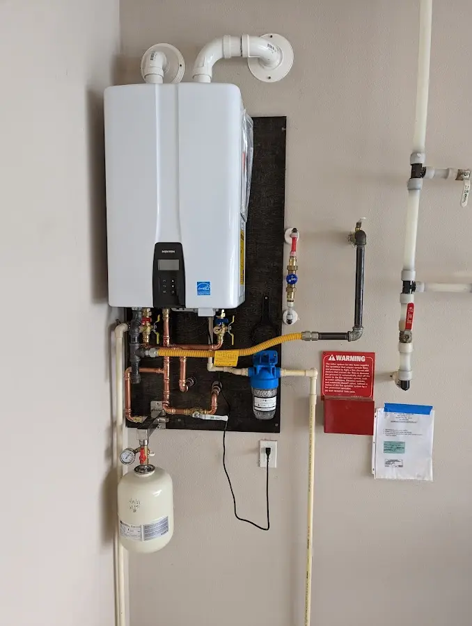 Professional plumber installing copper piping in a La Vale home